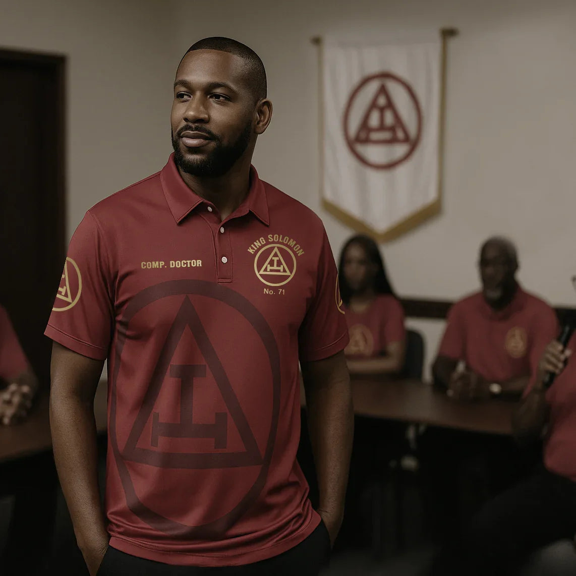 Man wearing a red polo shirt with a logo in an indoor setting